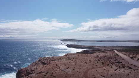 Bright-sunlight-reflects-off-the-waves-along-the-ocean-shoreline-on-a-sunny-day