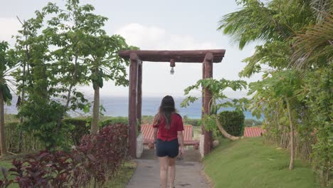 back view of a girl walking at a park during a windy morning