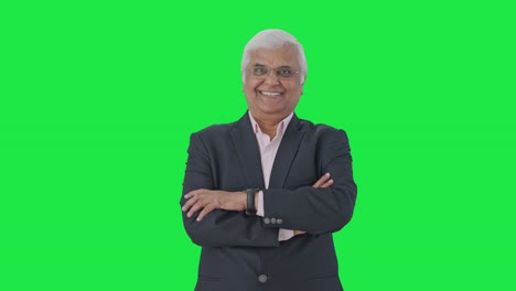 Happy-Indian-senior-businessman-standing-crossed-hands-Green-screen