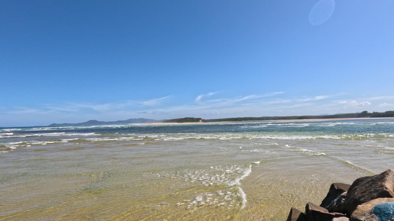 파도 와 은 하늘 이 있는 평화로운 해변 장면