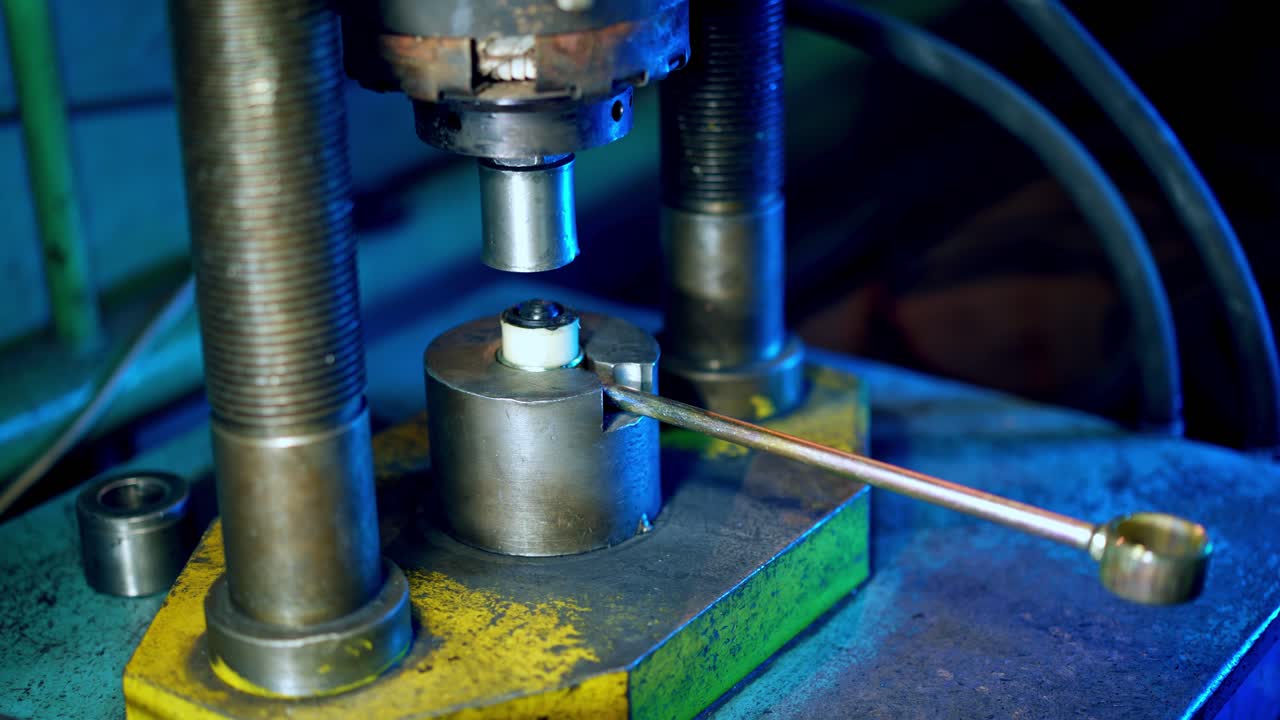 Industrial worker on metal press machine. Worker operating metal press machine at workshop