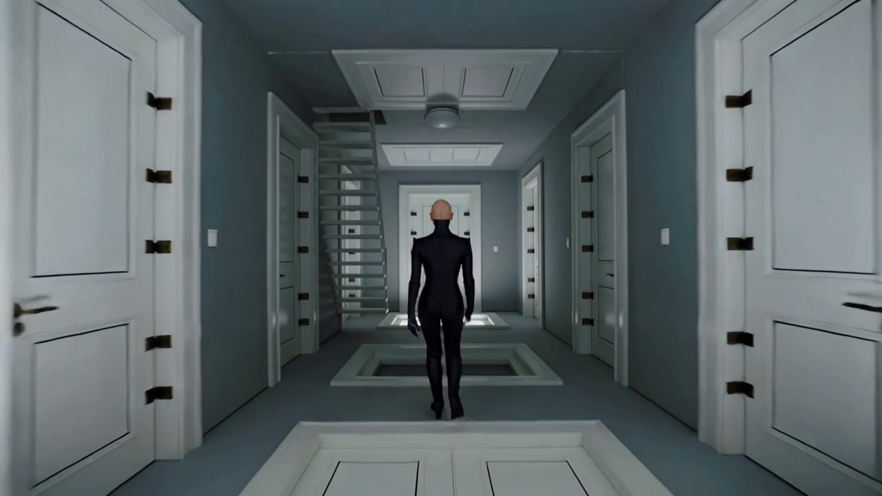 Stepping onto lit panel, person in dark suit walking down hall between white doors toward door