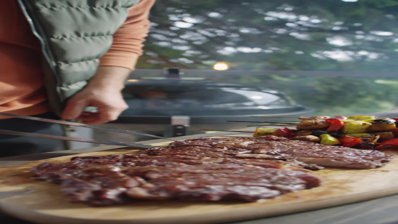 Cutting Meat Cooked on BBQ