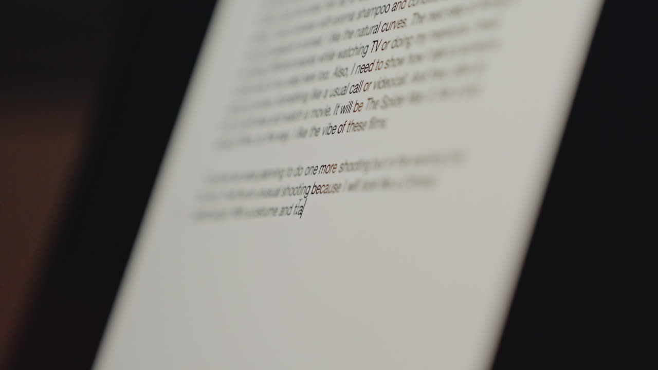 Closeup tablet screen showing hotel guide blurred text lines under soft warm lighting shallow depth of field minimal interface details bedside digital directory for guest information cinematic bokeh