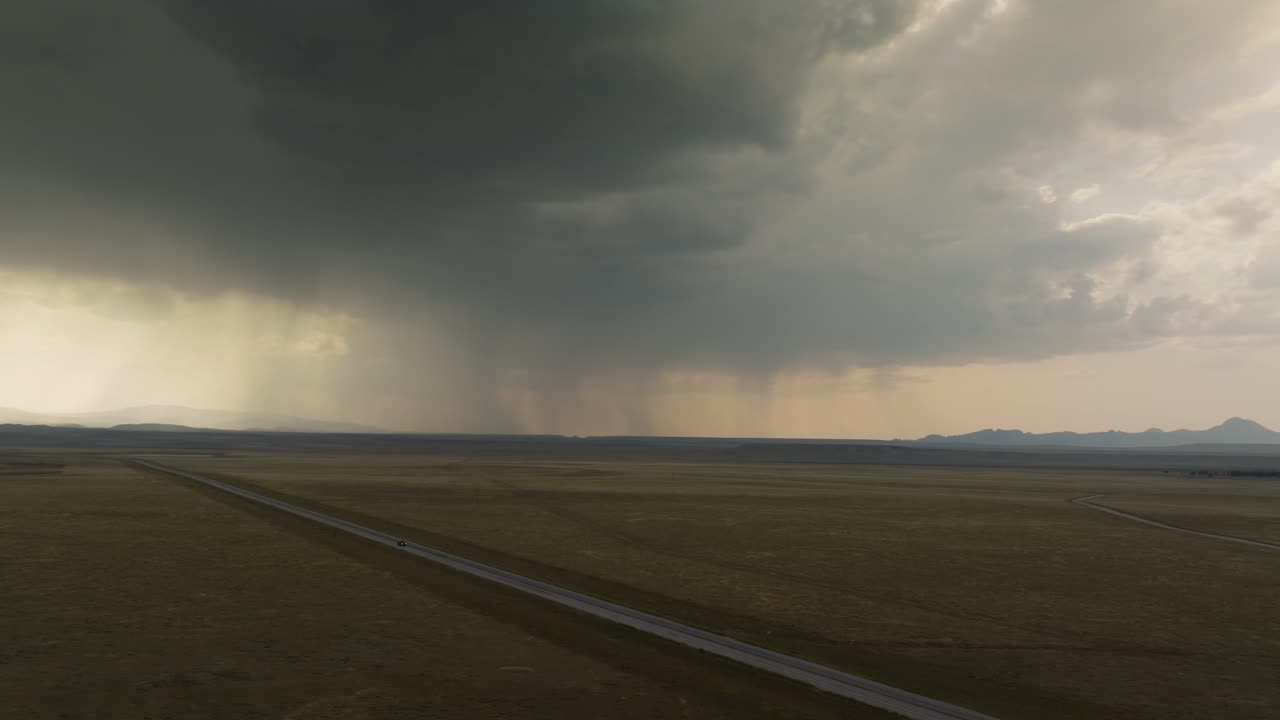 Stormy sky over a long road in Wyoming, evoking awe and wanderlust