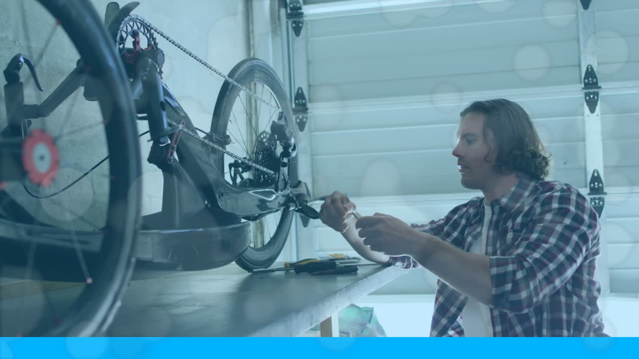 자전거를 수리하는 백인 남자의 위로 움직이는 모양의 애니메이션