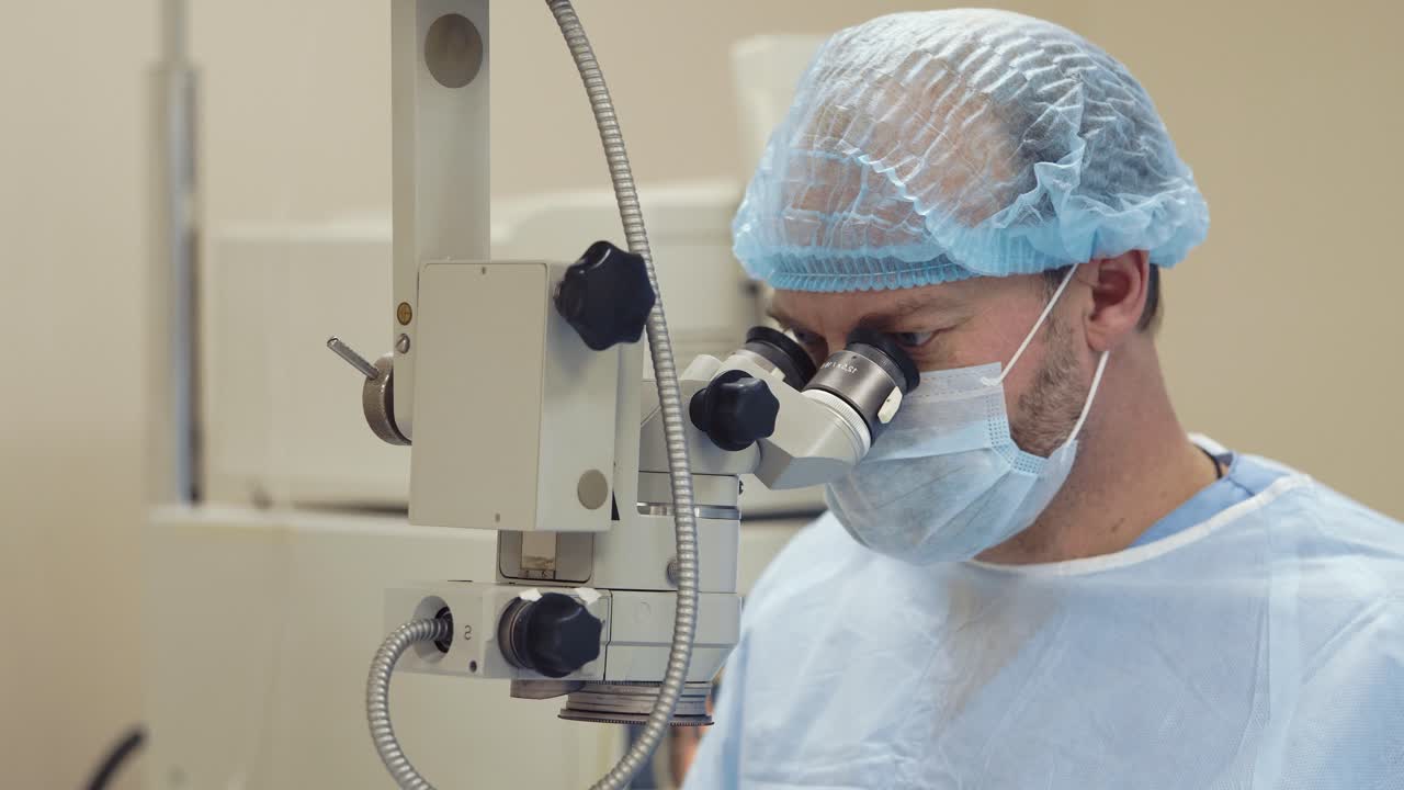 Ophthalmologist using a microscope