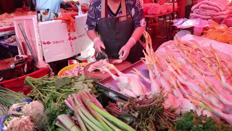 butcher skillfully preparing meat at a busy market