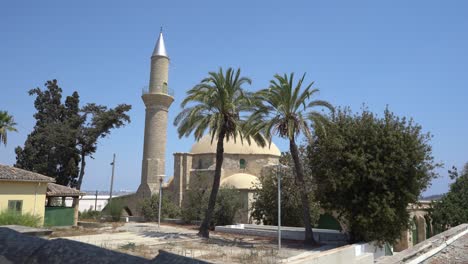 larnaca, cyprus, september 2021: hala sultan tekke mosque on the background of a salt lake. dried up salt lake. natural salt on the surface of the earth.