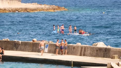 group of people on floating platform in the sea