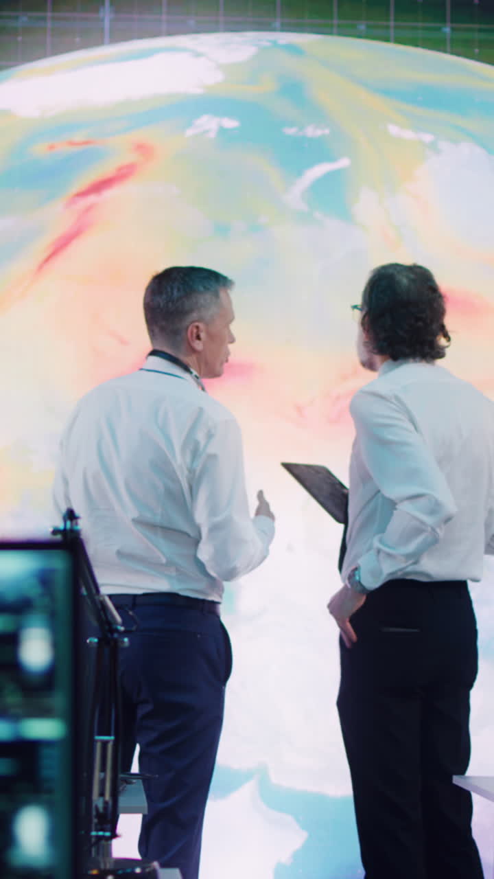 los científicos monitorean el clima de la tierra en una sala de control.