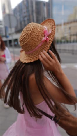 woman in a straw hat and pink dress