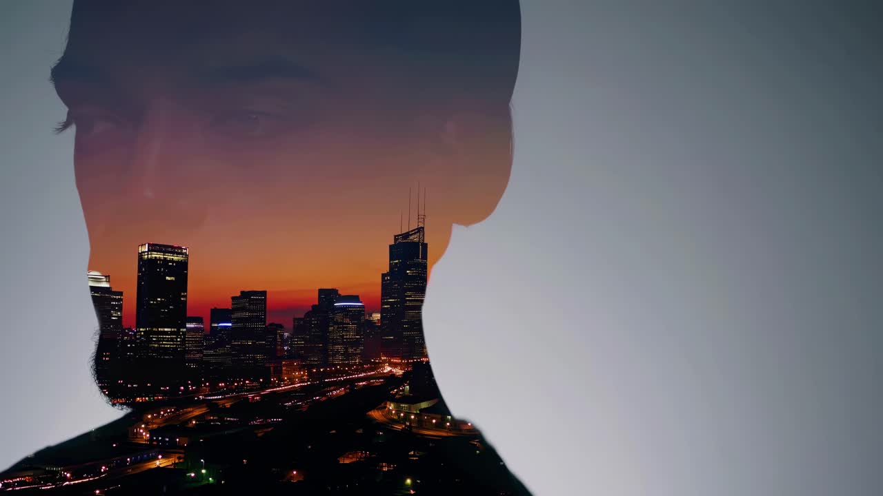 Double exposure video concept blending a man's profile with a cityscape at sunset