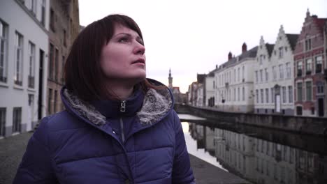 girl walks and looks at attractions in the city of bruges belgium