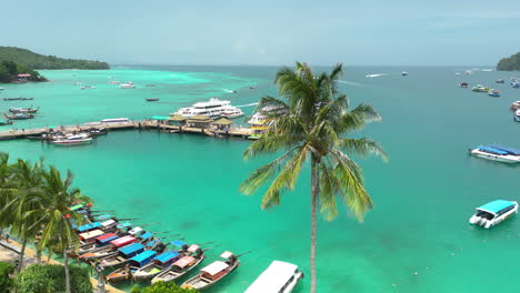 Traditional-longtail-and-modern-tourist-boats-at-pier-on-paradise-Koh-Phi-Phi-island,-Thailand