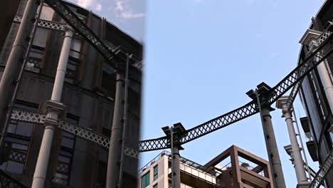 Reflection-of-the-Gasholders-through-the-glass-from-Gasholders-Park,-London,-United-Kingdom