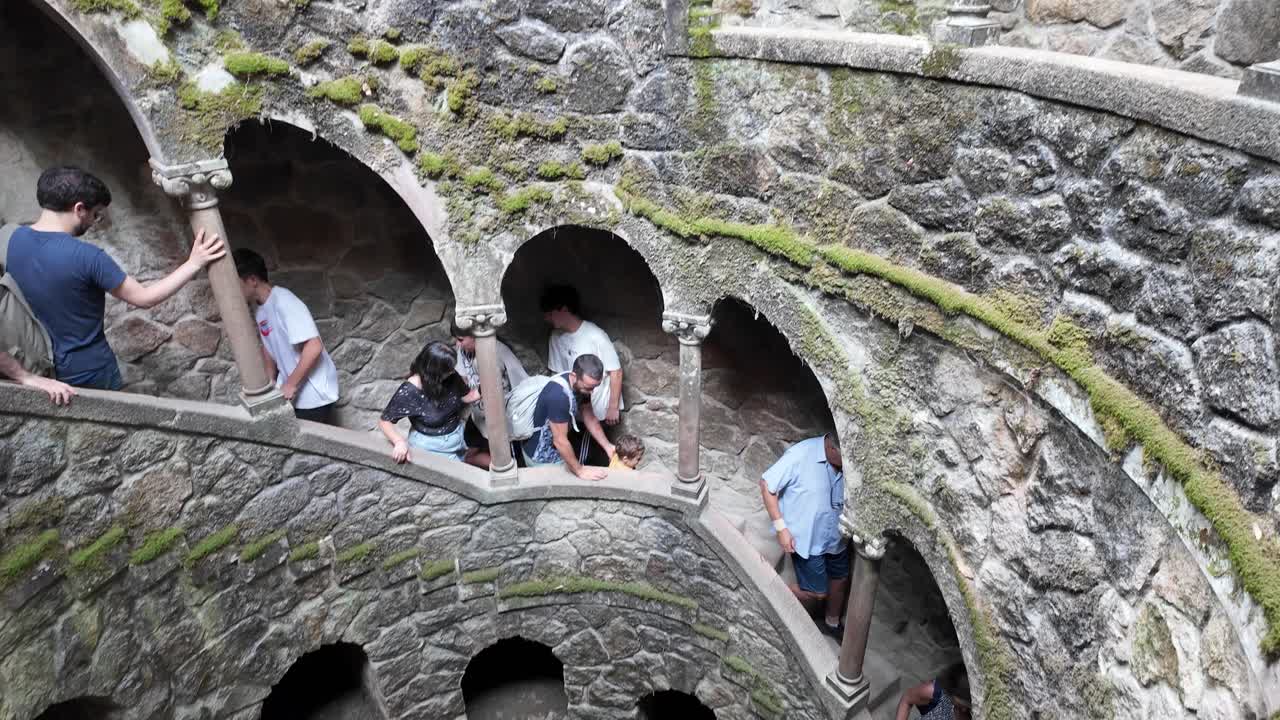 Moss-covered arches in the forest of Quinta da Regaleira, Sintra Portugal create a mystical scene