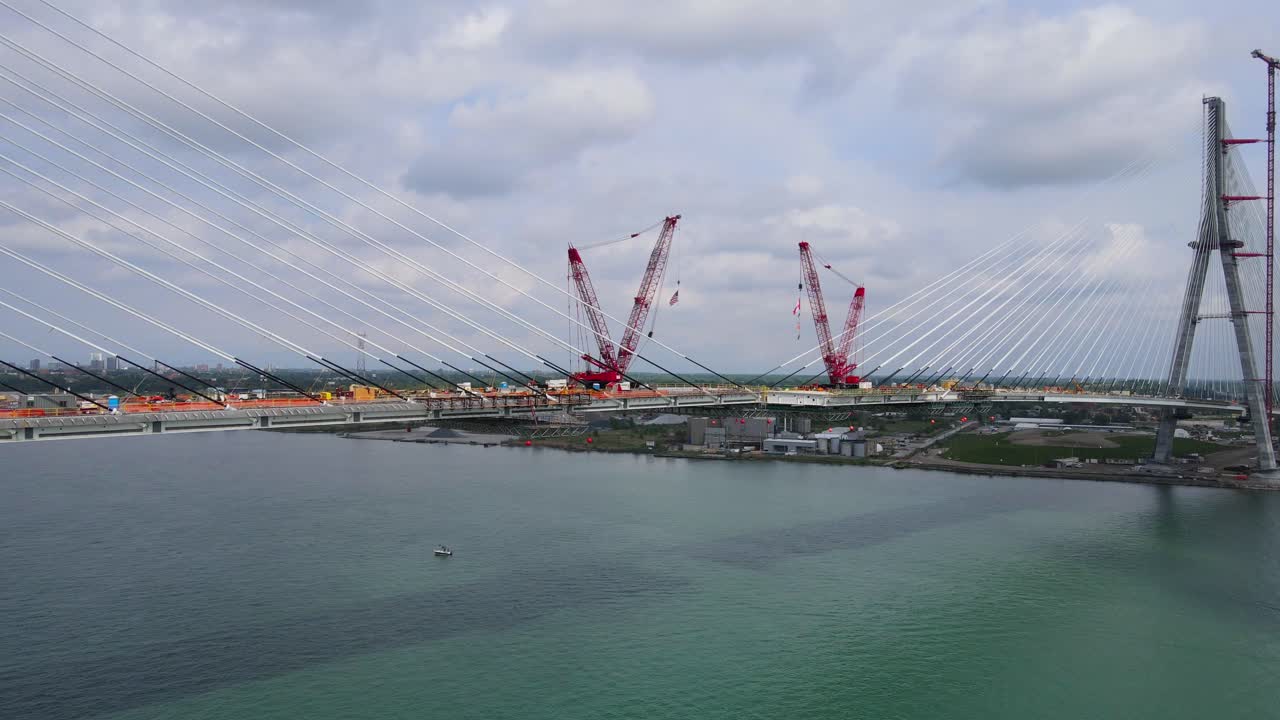 Suspension cables and cranes in Gordie Howe International Bridge construction final phase