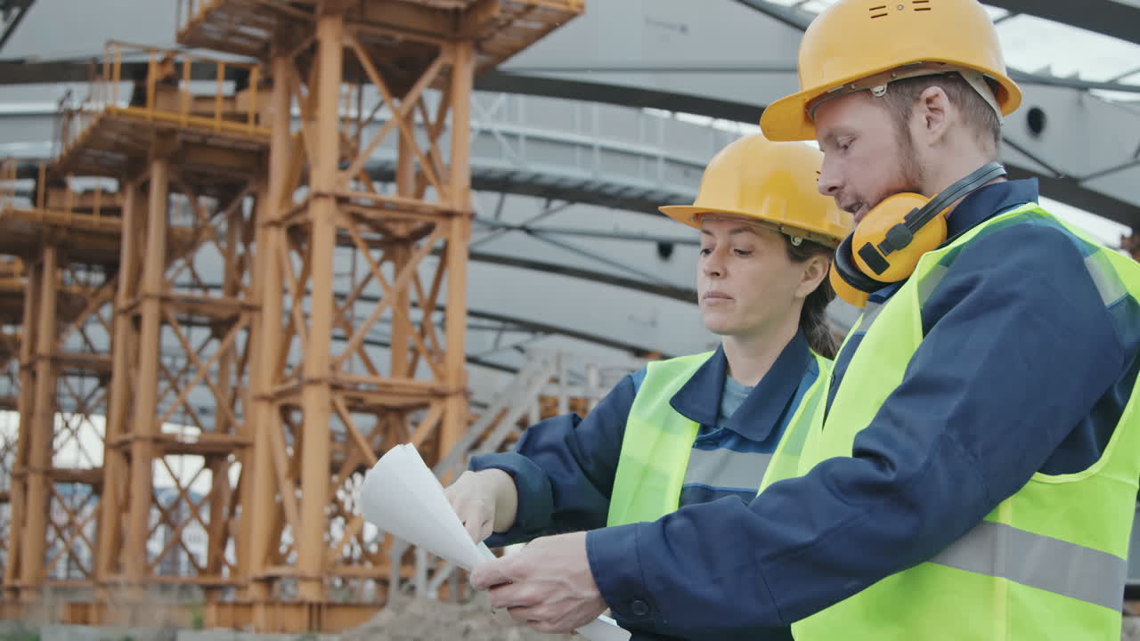 Construction Site Workers Discussing Blueprint
