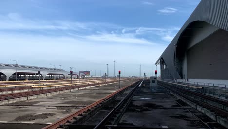 View-Of-Empty-Railways-At-The-Train-Depot-In-Bangkok,-Thailand---tilt-down-shot