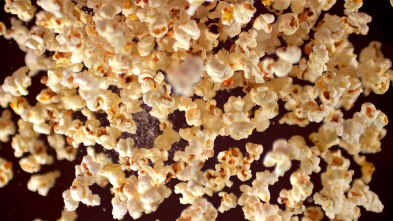Freshly Popped Popcorn Falling with Salt in Slow Motion
