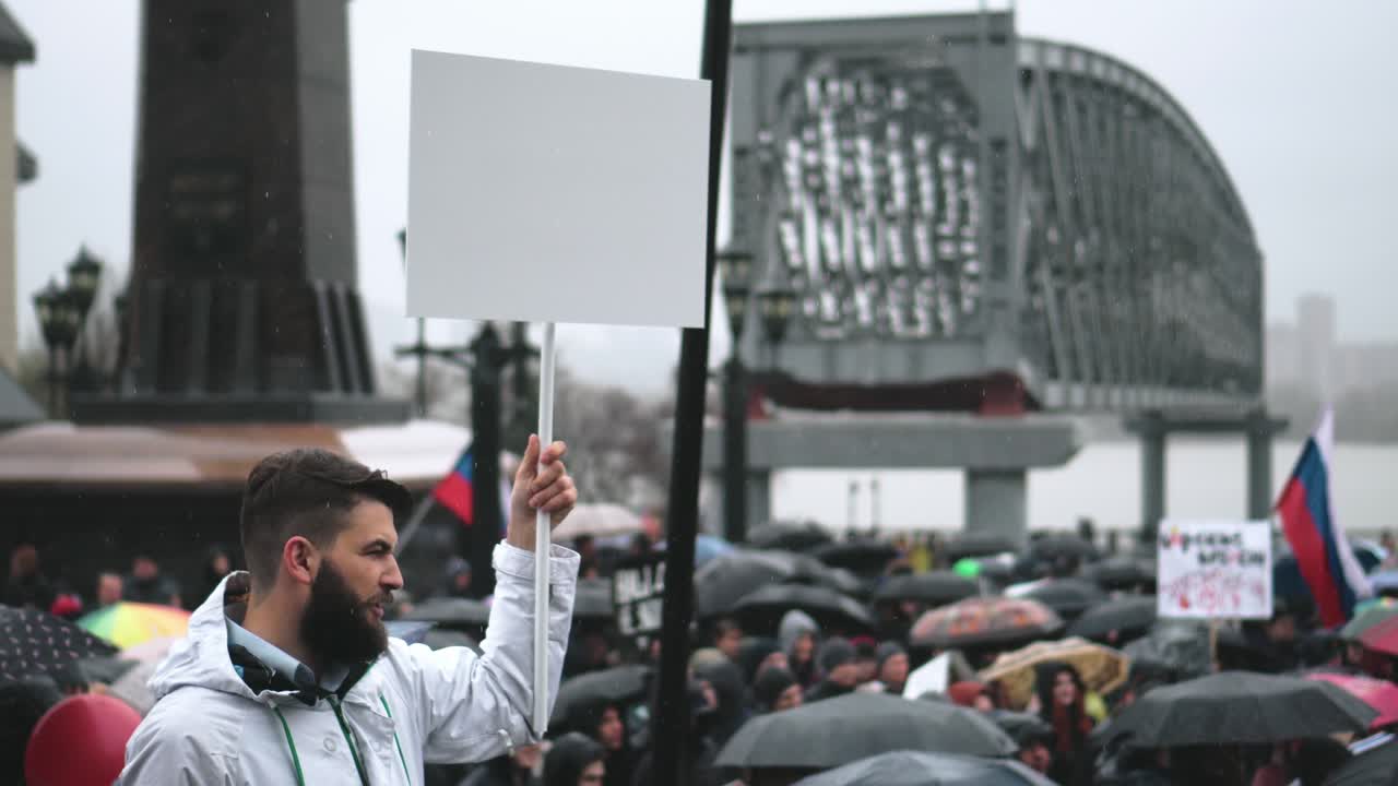 Protest person holds empty banner for advertisement. Blank copyspace for logo.