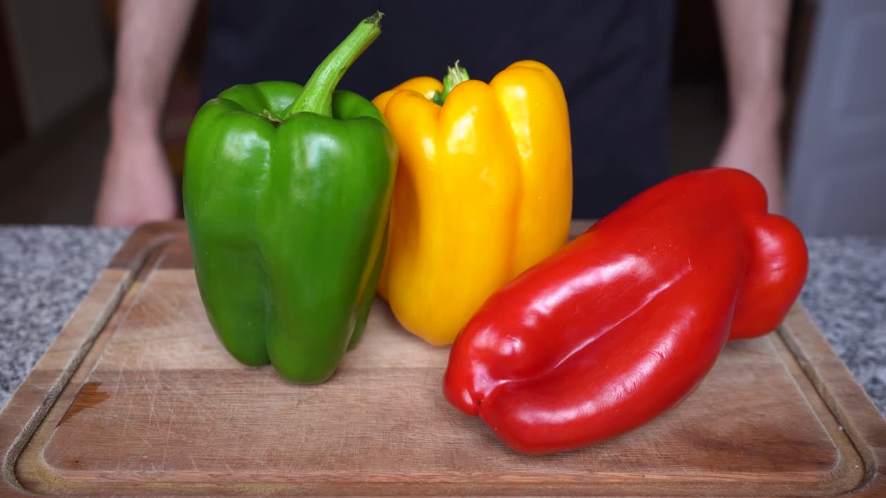 Different varieties of peppers on a wooden board