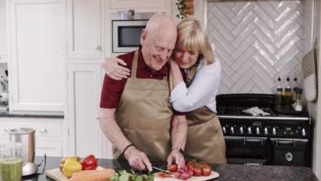 elderly couple cooking together in the kitchen