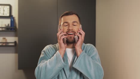 a cute man in a bathrobe is holding bills to his face