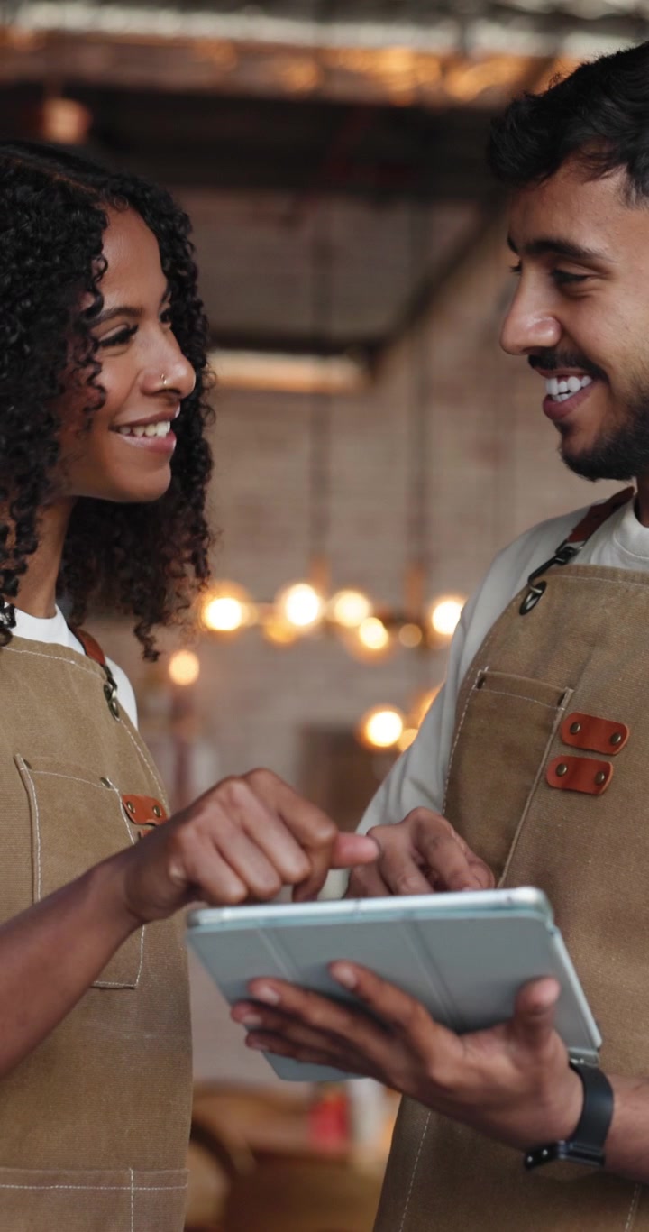 Two Cafe Workers Celebrating Success with a High Five