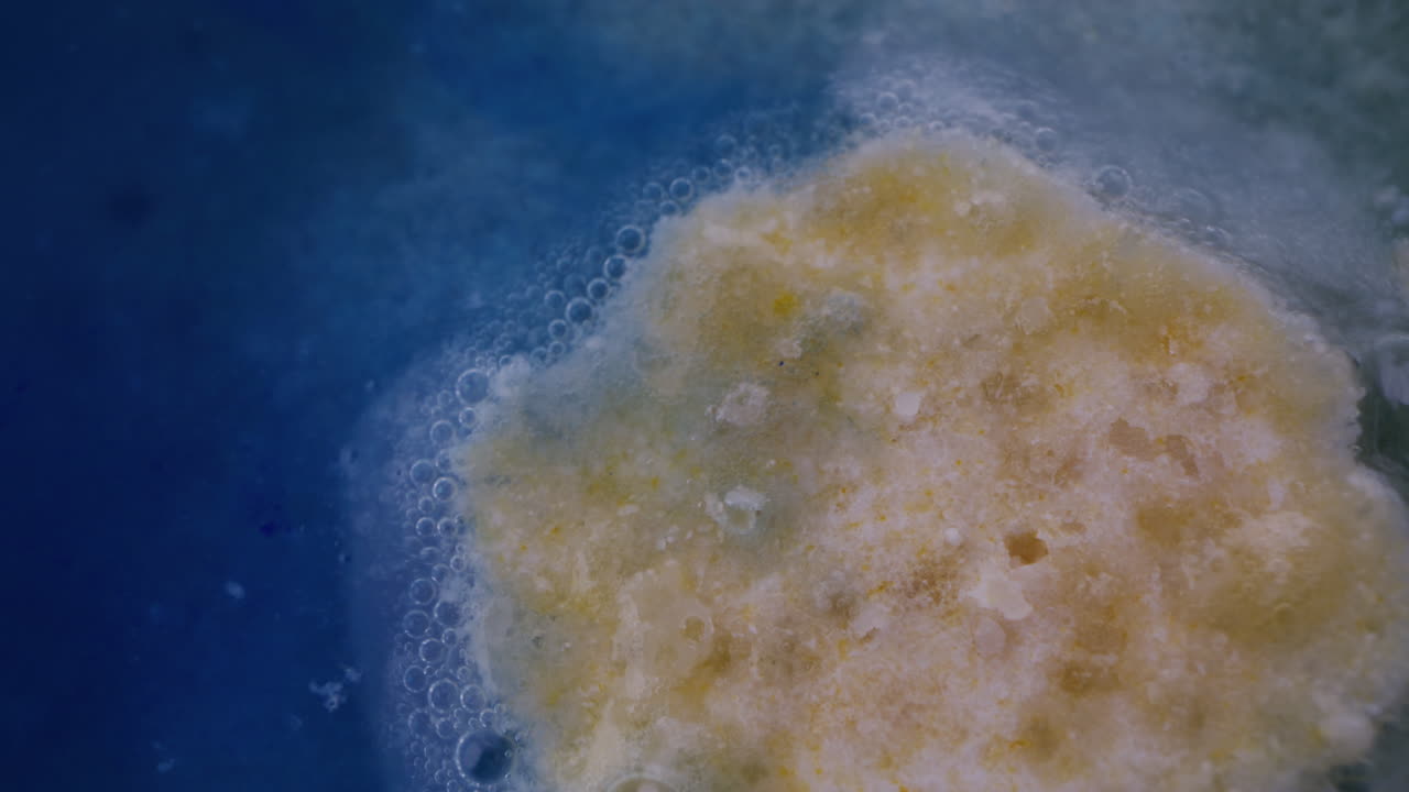 Close-up of a substance in water with bubbles