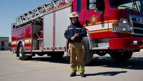firefighter in front of firetruck