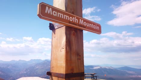 gimbal shot booming up on the marker at the summit of mammoth mountain in california