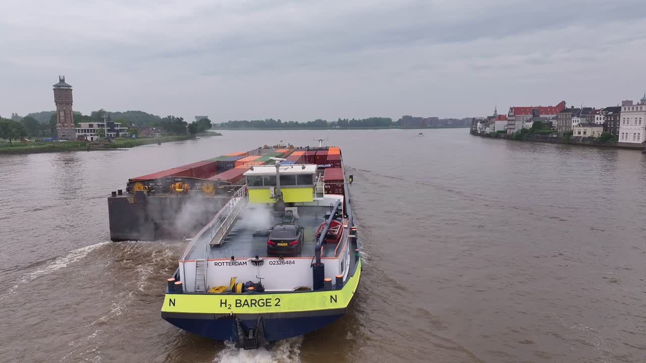 Barge carrying containers on a river in the Netherlands