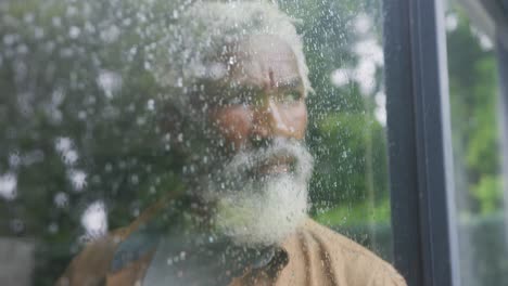 video of sad african american senior man looking out the window