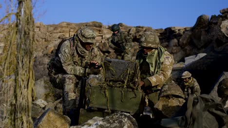 armed african american soldier looking at a computer