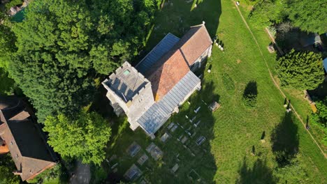 a top-down roll-shot of st andrew's church and graveyard in wickhambreaux