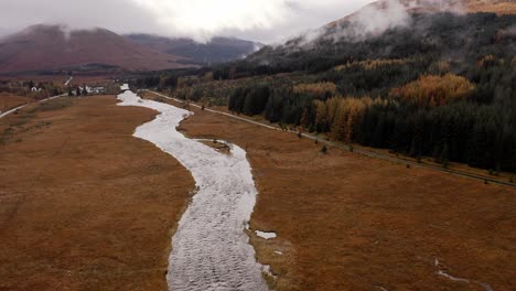 AERIAL---River-Orchy-next-to-road,-Glencoe,-Scottish-Highlands,-Scotland,-tilt-up