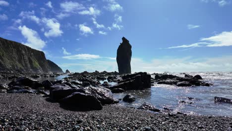 rocky beach gentle waves sea stack and blue spring sky in ballydwane beach in waterford ireland