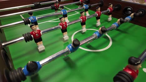 a close-up view of a foosball table during a game, showcasing the intense action and strategic gameplay