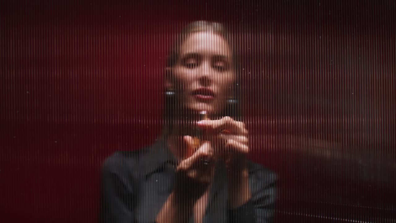 mujer elegante detrás de un vidrio rojo