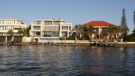 kayakers paddling past waterfront homes