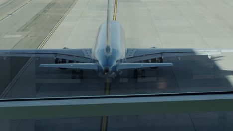 twin jet engine aircraft taxiing to leave the terminal at laguardia airport new york - ready for takeoff - day