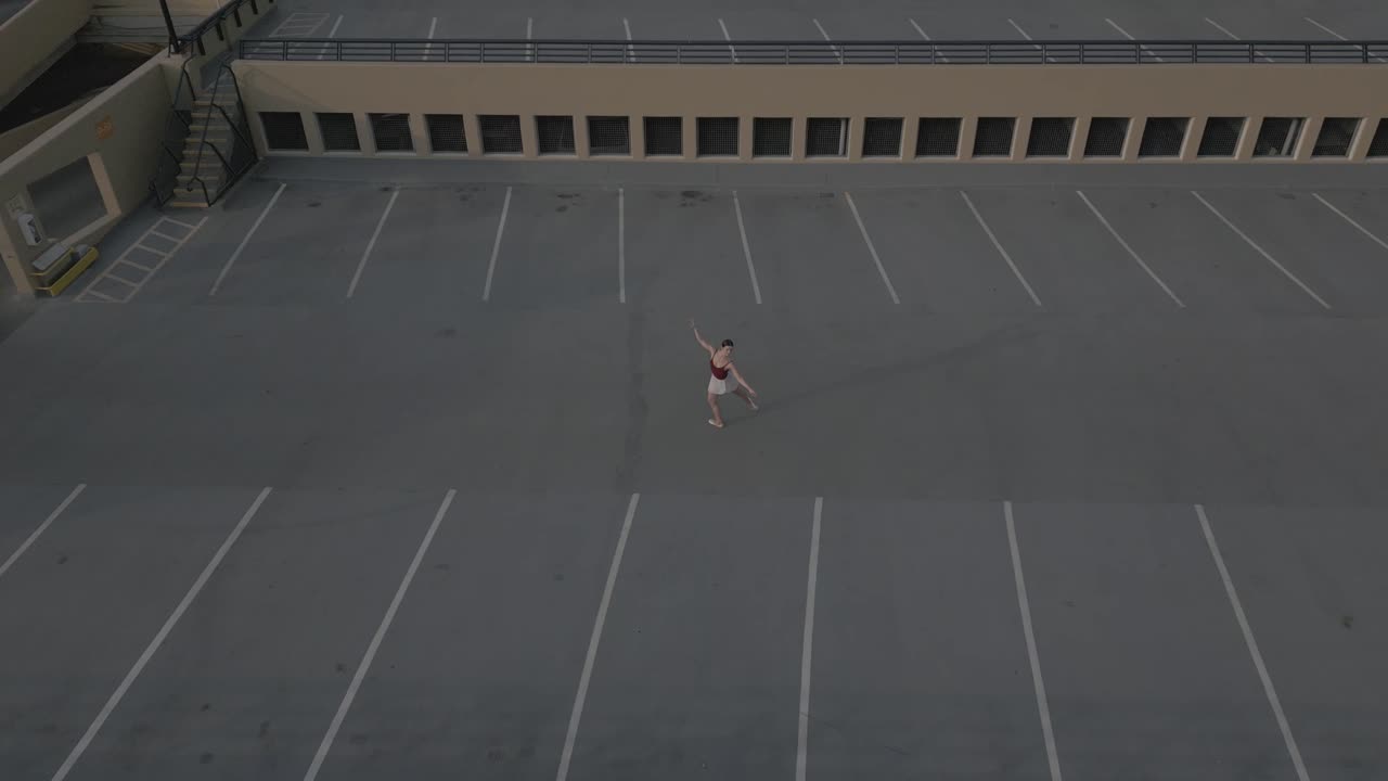 Drone flying over ballet dancer on parkade roof