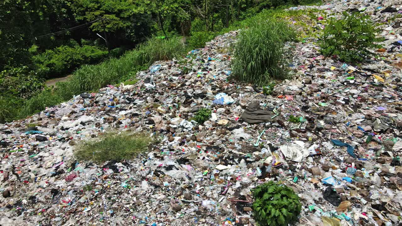 Tracking shot of a Garbage landfill site in the tropics