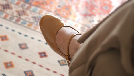 closeup of a pair of brown leather ankle strap heels