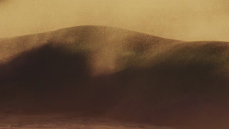 detailed telephoto view of light behind clear water as soft early morning light dances across waves as offshore winds pull ocean spray mist over top