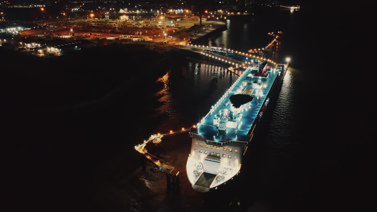Aerial drone view of a yacht at night in Liverpool, England