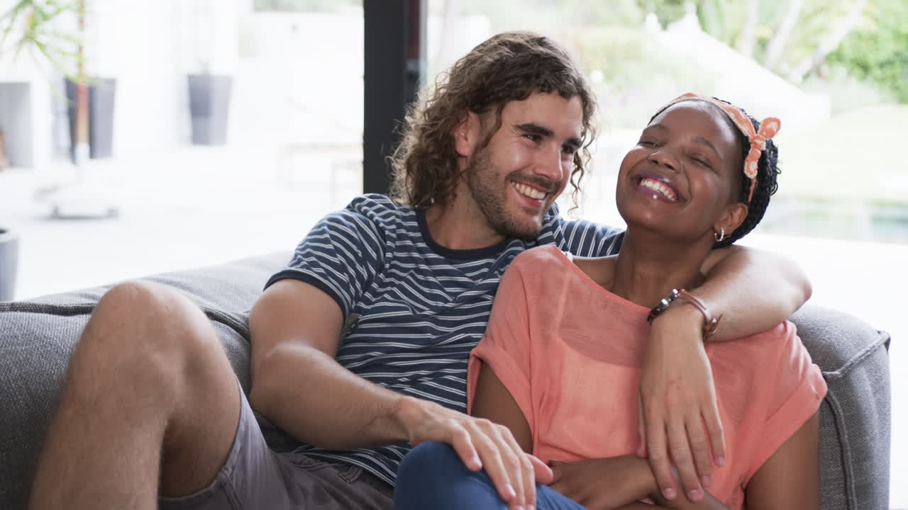 Diverse couple enjoys a cozy moment at home