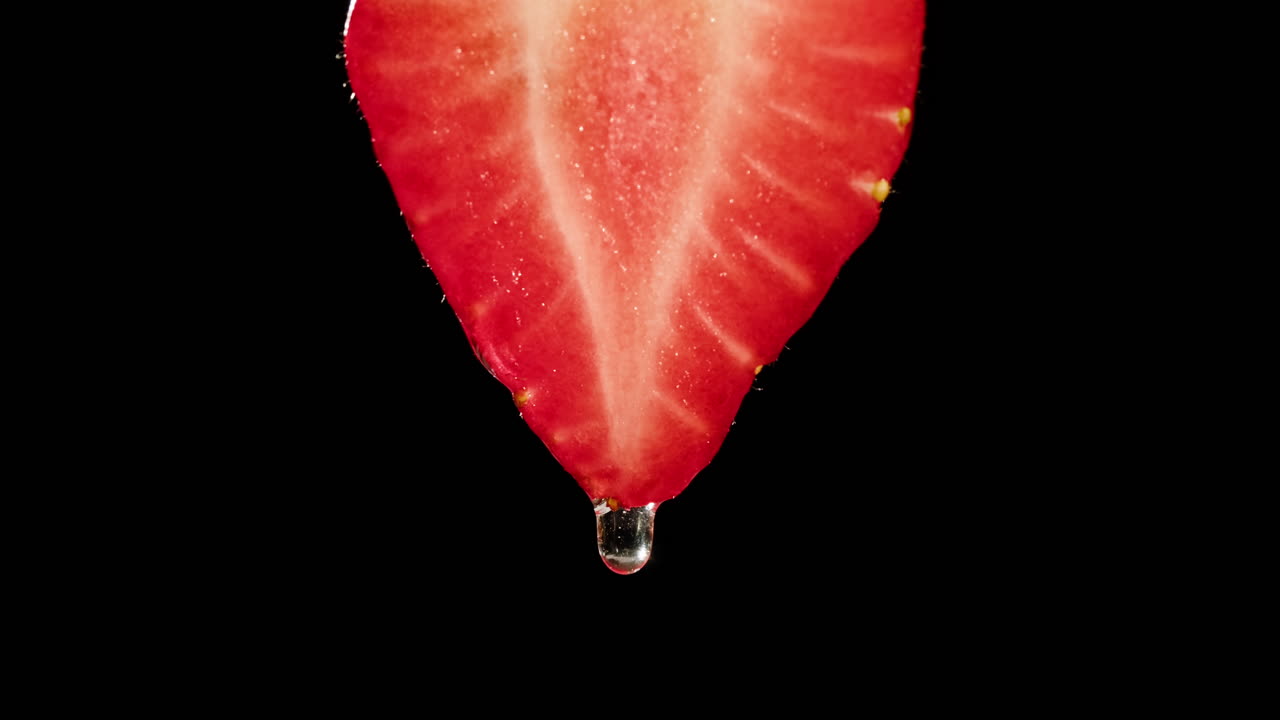 Close-up of a strawberry slice with water droplet